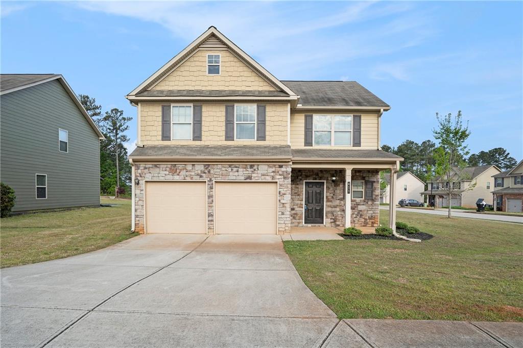 411 Bandelier Circle Hampton, GA 30228 - Photo 1 of 1 a front view of a house with a yard and garage