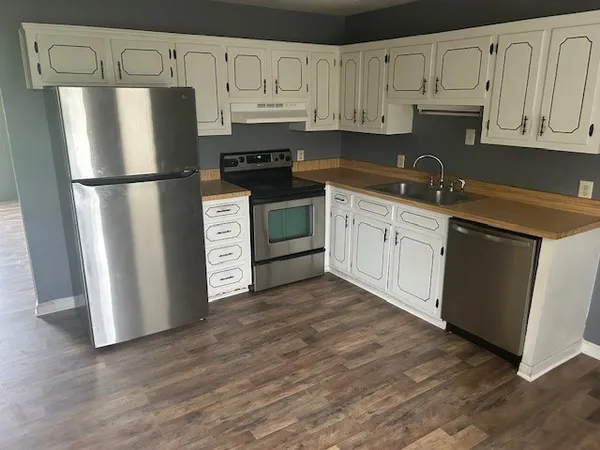 a kitchen with stainless steel appliances granite countertop a refrigerator sink and cabinets