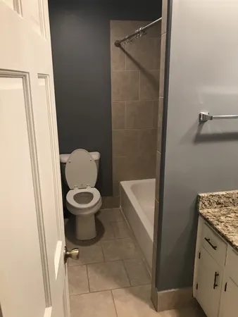 a bathroom with a toilet and a shower