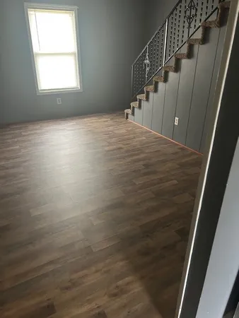 a view of entryway and hall with wooden floor