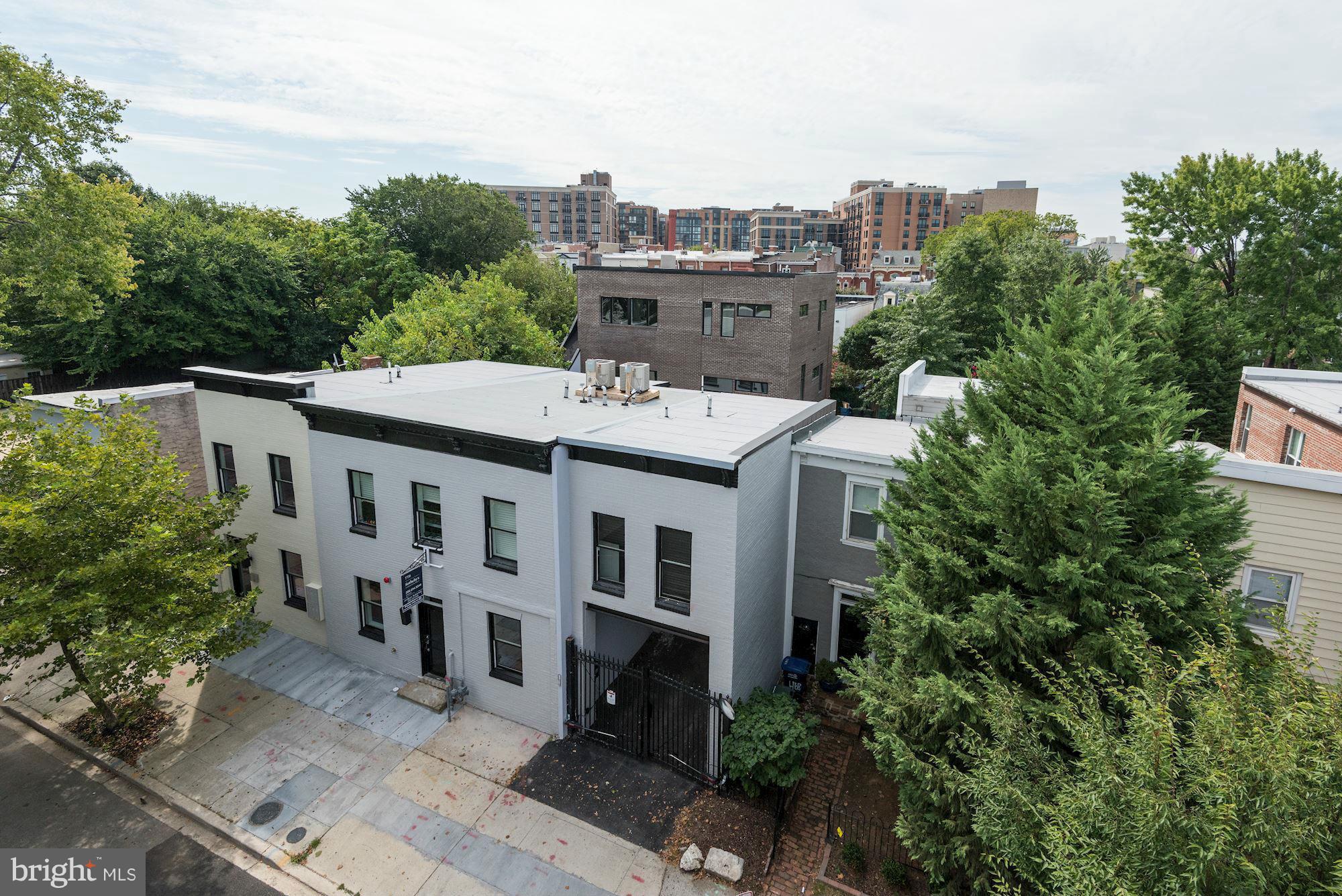 460 Ridge Street Northwest, Unit 1 Washington, DC 20001 - Photo 1 of 28 a view of a white building among the street and trees
