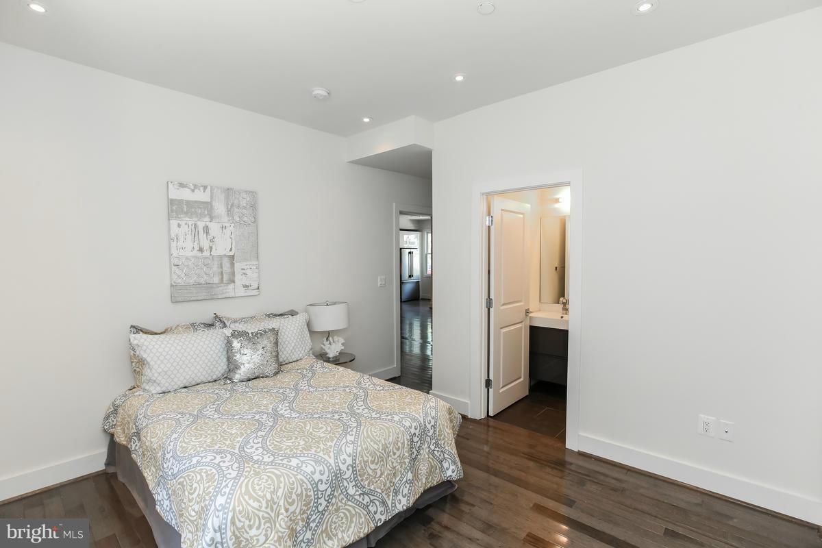 460 Ridge Street Northwest, Unit 1 Washington, DC 20001 - Photo 15 of 28 a bedroom with a bed and wooden floor
