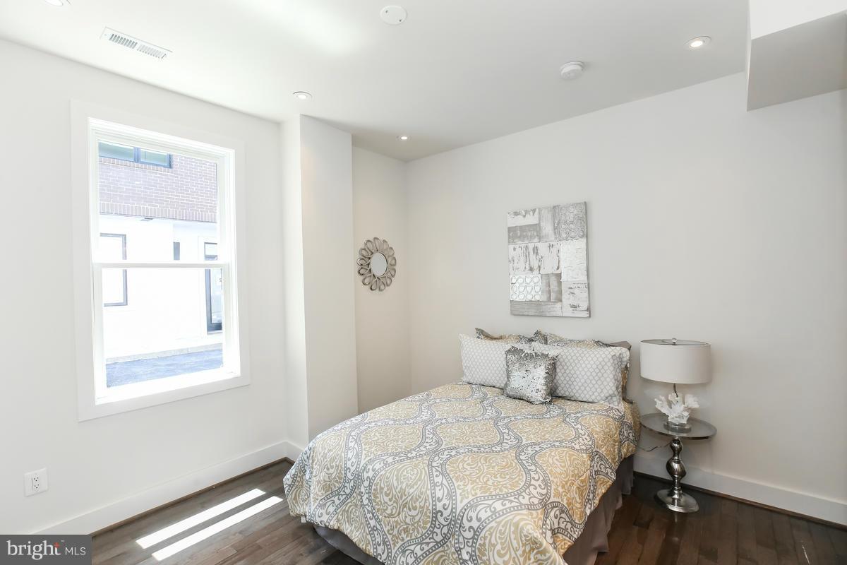 460 Ridge Street Northwest, Unit 1 Washington, DC 20001 - Photo 16 of 28 a bedroom with a bed and a window
