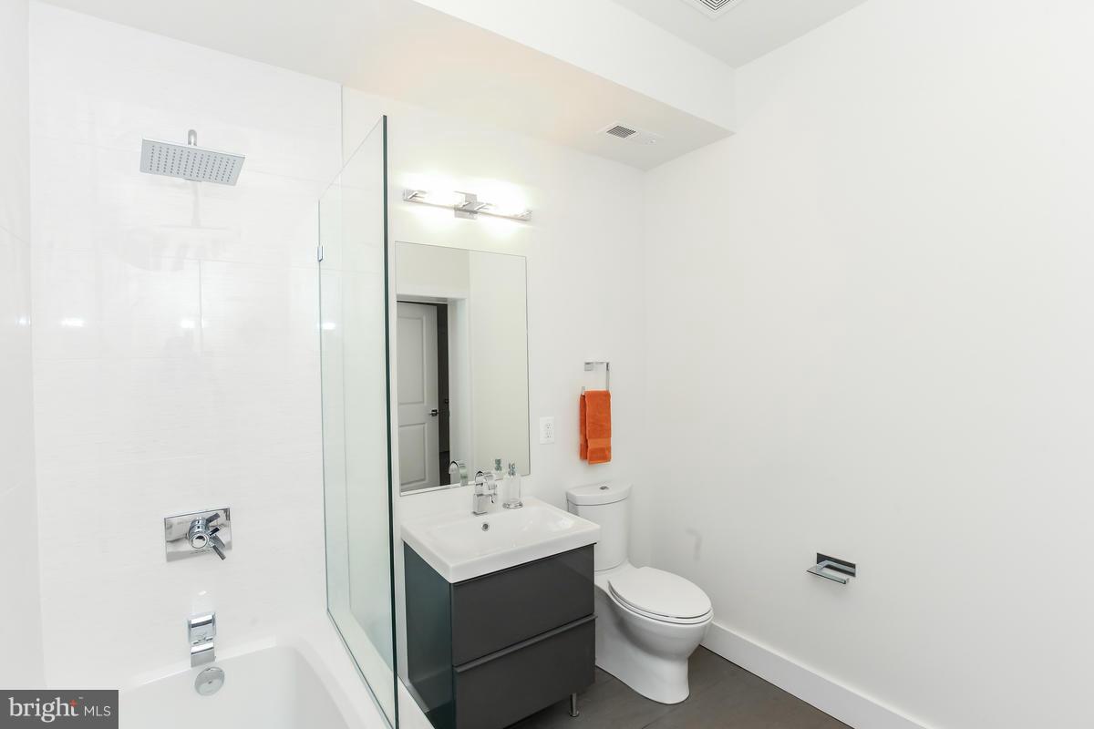460 Ridge Street Northwest, Unit 1 Washington, DC 20001 - Photo 22 of 28 a bathroom with a toilet sink and mirror