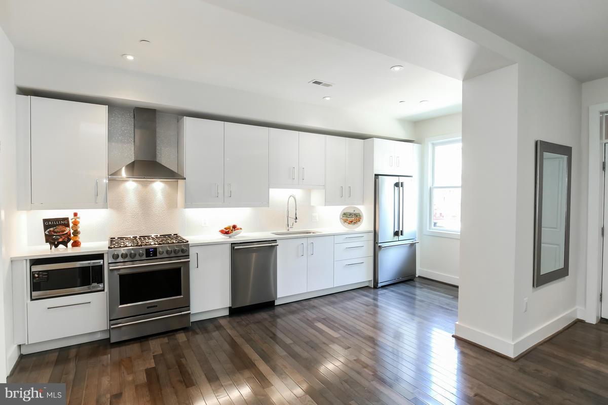 460 Ridge Street Northwest, Unit 1 Washington, DC 20001 - Photo 4 of 28 a kitchen with a stove and a refrigerator