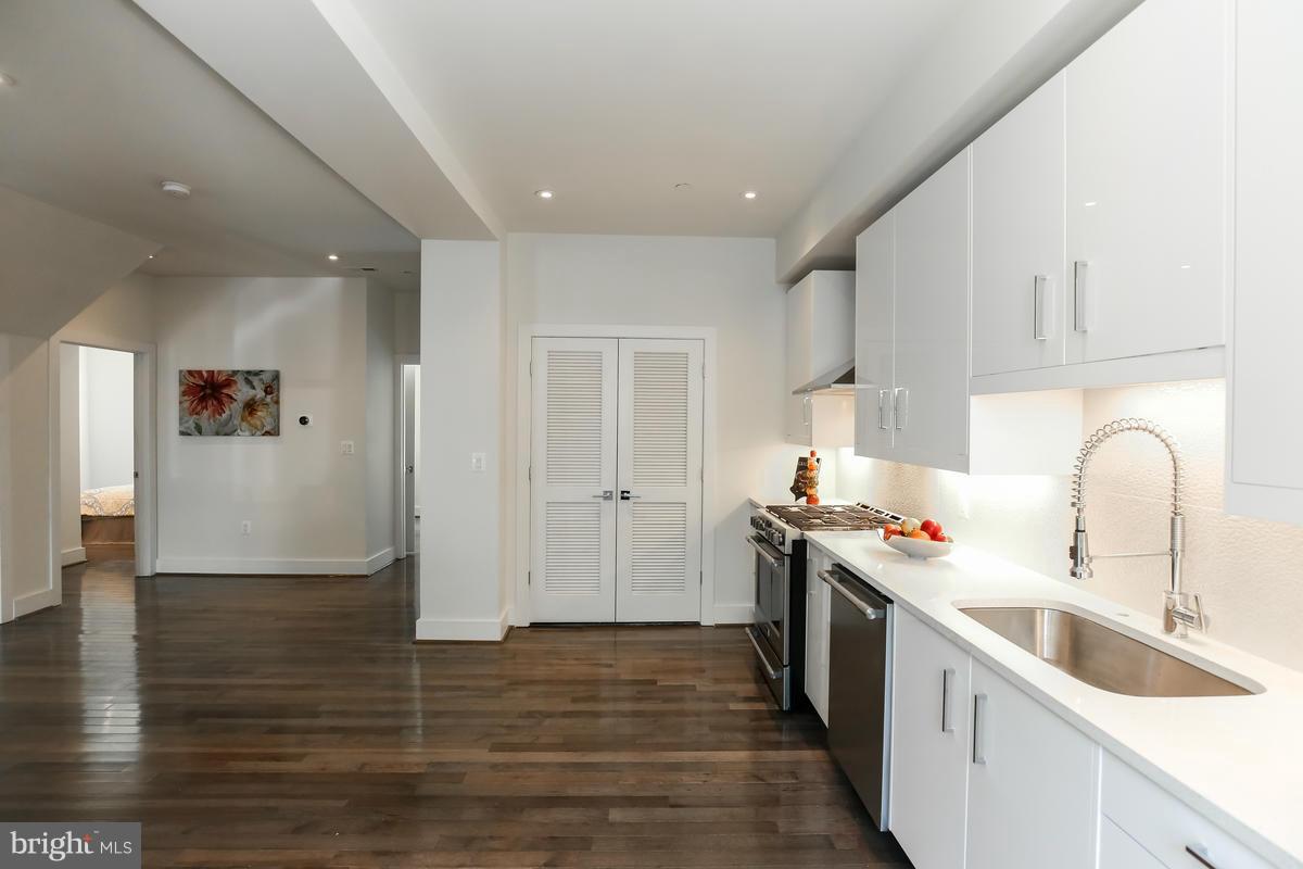 460 Ridge Street Northwest, Unit 1 Washington, DC 20001 - Photo 6 of 28 a kitchen with a sink cabinets and wooden floor