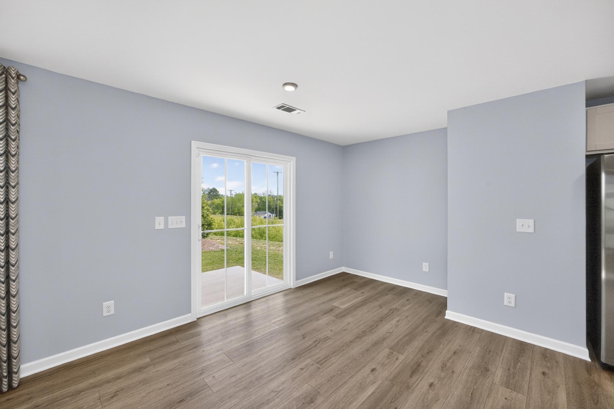 3004 Red Fox Ridge Madison, TN 37115 - Photo 8 of 45 a view of an empty room with wooden floor and a window