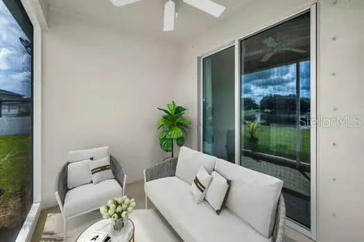 a living room with furniture and a potted plant