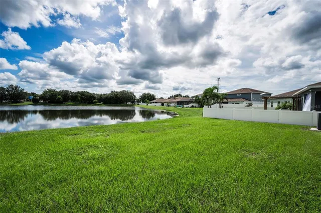 a view of a lake with houses in the back