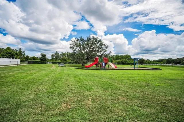 a view of a park with swings and slides