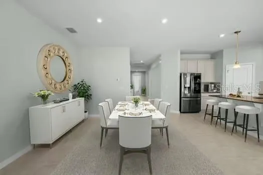 a kitchen with a dining table cabinets and chairs