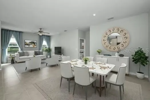 a dining room with livingroom view and wooden floor