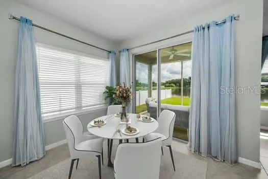 a view of a dining room with furniture window and outside view