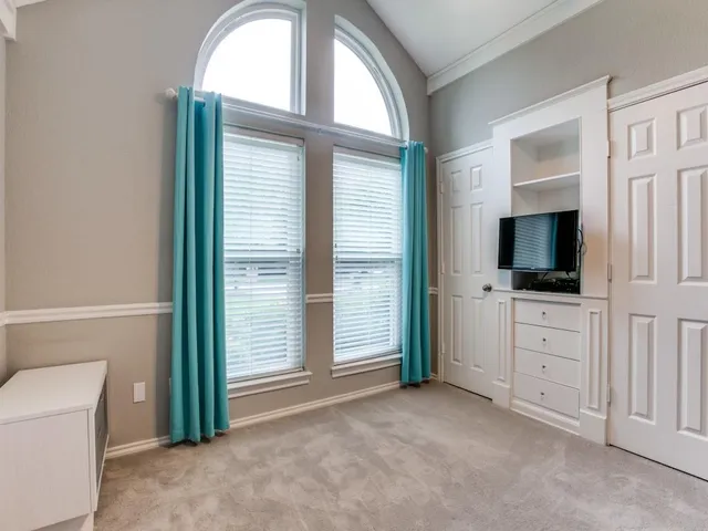 a view of room with flat screen tv and a window