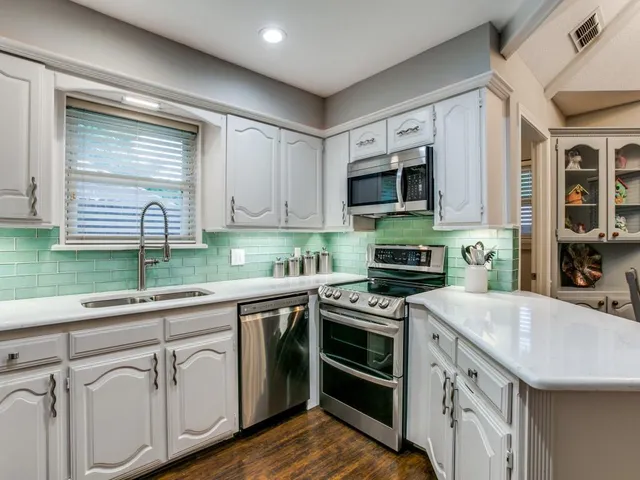 a kitchen with stainless steel appliances granite countertop a stove and a sink