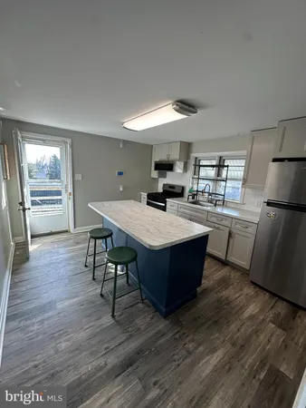 a room with wooden floors and wooden cabinets