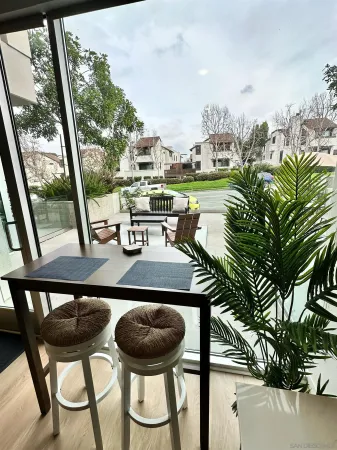a view of a chairs and table in the balcony