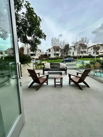 a swimming pool with outdoor seating and wooden fence