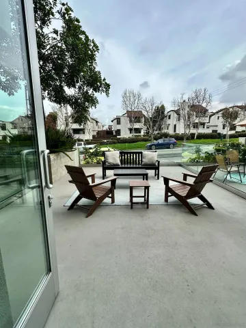a swimming pool with outdoor seating and wooden fence