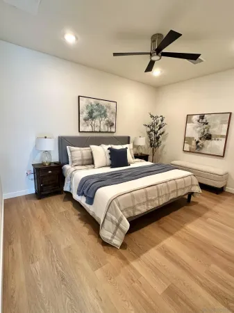 a bedroom with a bed and a painting on the wall