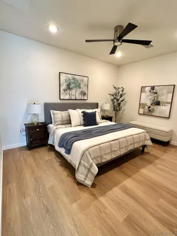 a bedroom with a bed and a painting on the wall