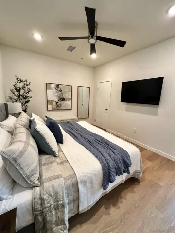 a bedroom with a large bed and a tv