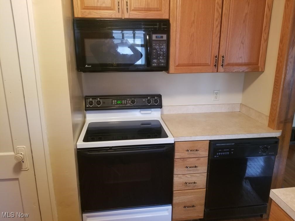 218 Canton Road Akron, OH 44312 - Photo 7 of 19 Kitchen featuring black appliances and light countertops