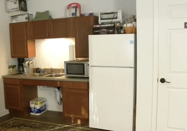 a kitchen with a refrigerator and a stove