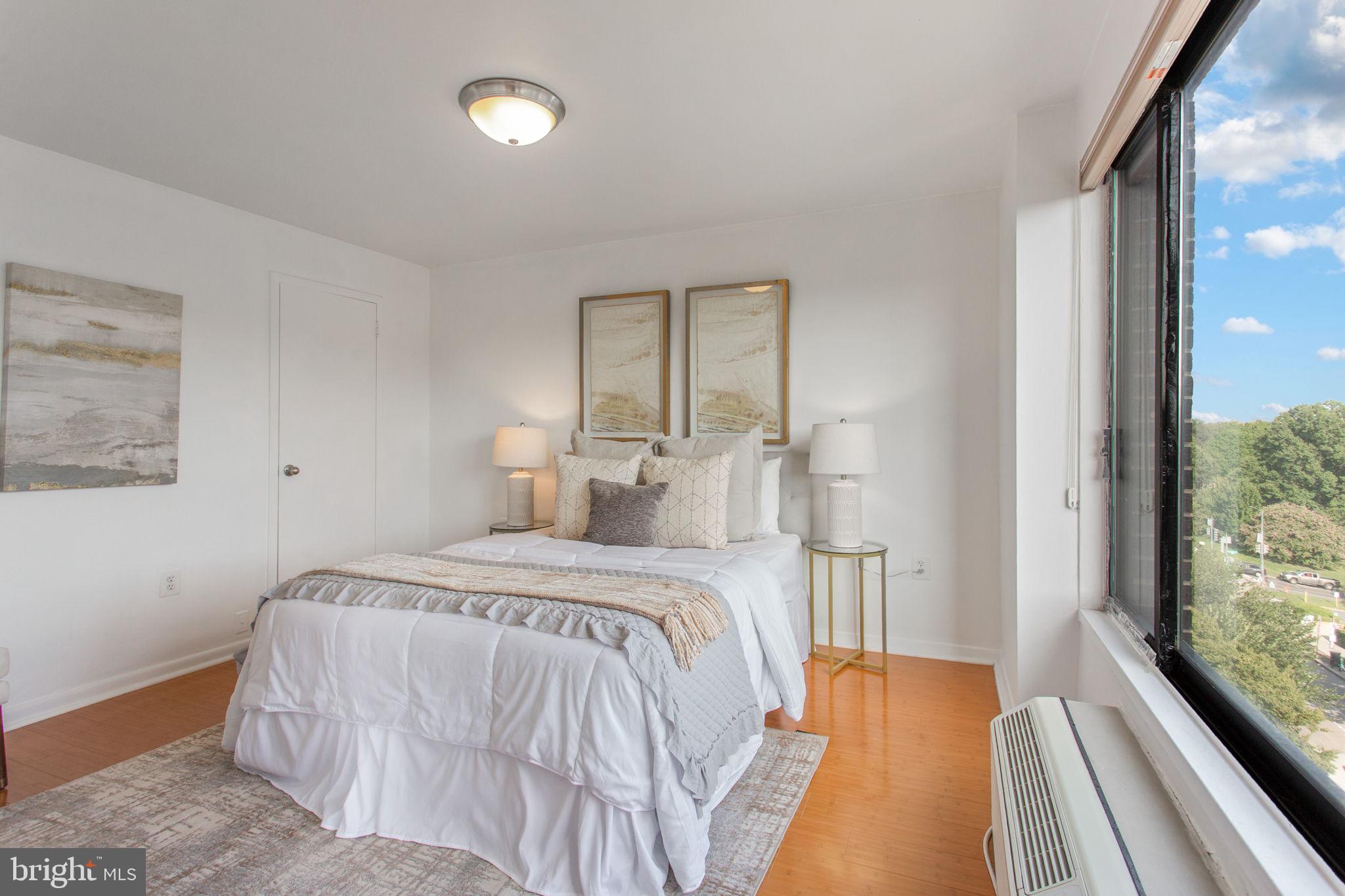 2501 Calvert Street Northwest, Unit 802 Washington, DC 20008 - Photo 12 of 20 a bedroom with a bed and a large window