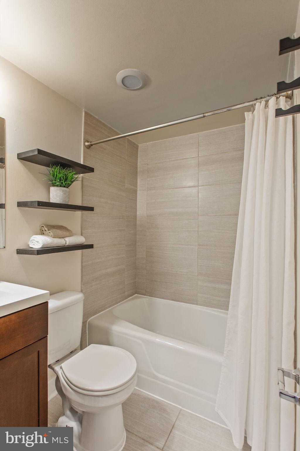 2501 Calvert Street Northwest, Unit 802 Washington, DC 20008 - Photo 18 of 20 a bathroom with a shower a toilet and a sink