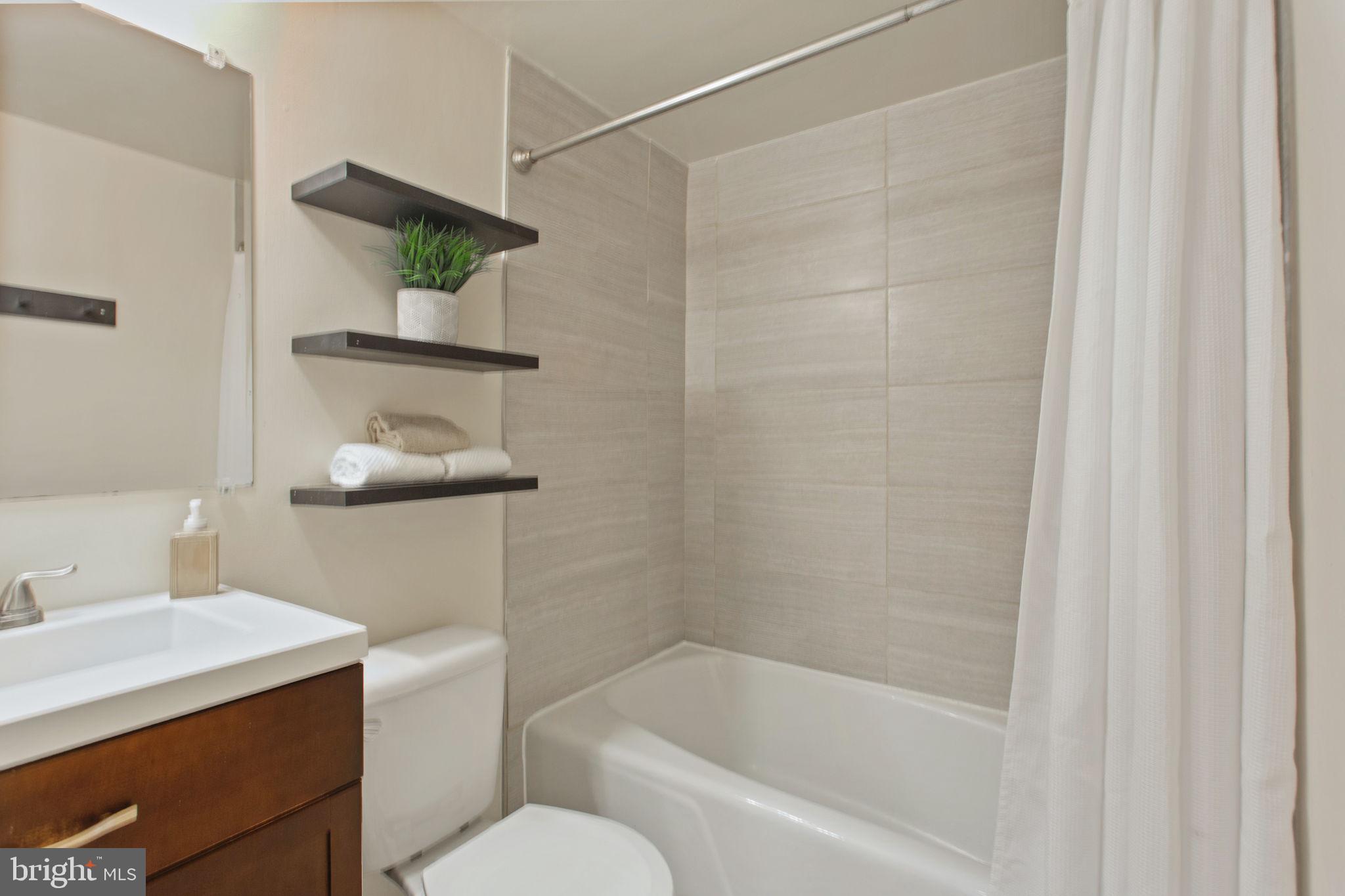 2501 Calvert Street Northwest, Unit 802 Washington, DC 20008 - Photo 19 of 20 a bath room with a toilet and a bath tub