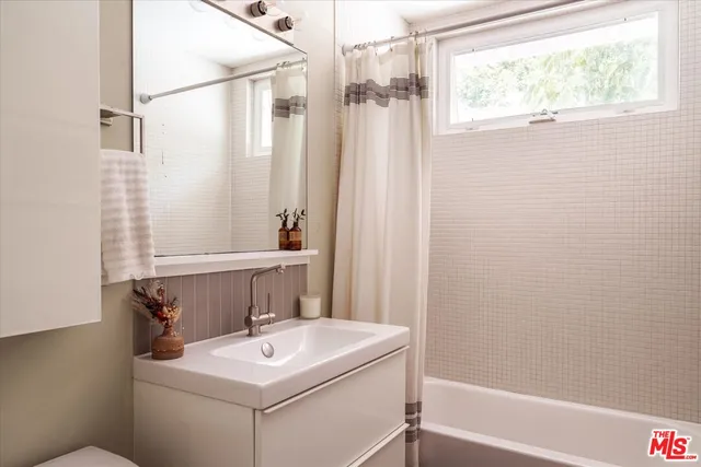 a bathroom with a sink toilet and tub