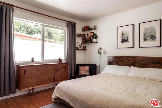 a bedroom with a large bed and a window