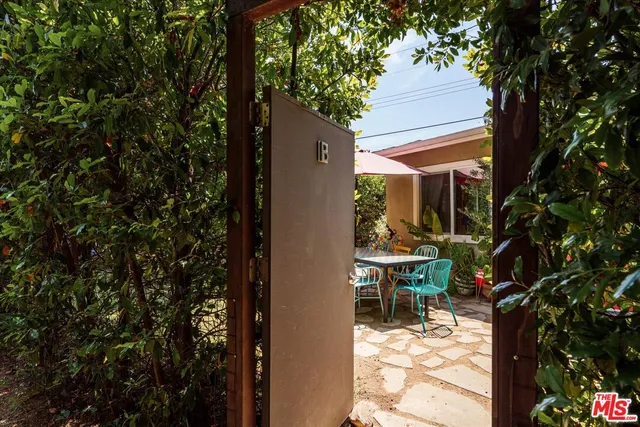 a view of balcony of a house with wooden floor and outdoor seating