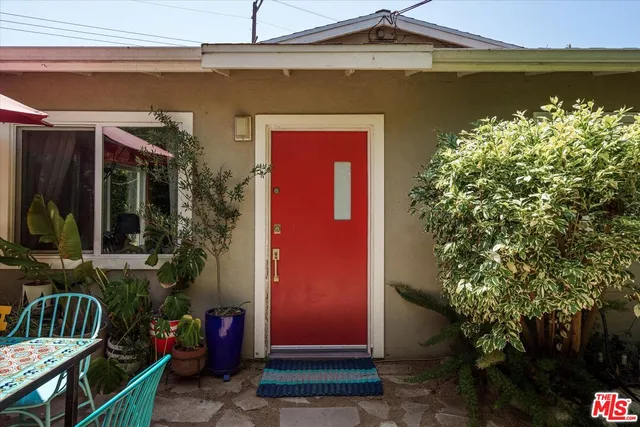 a front view of a house with lake view and a potted plant