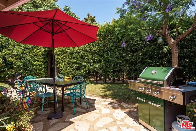 an outdoor space with furniture and umbrella