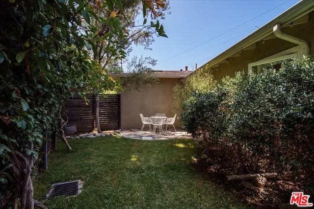 a view of a chair and table in backyard