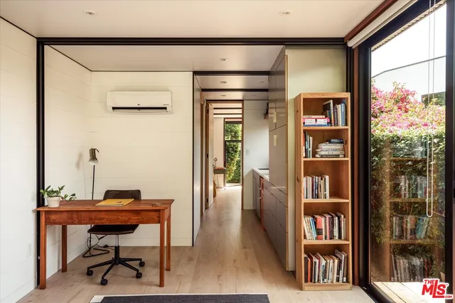 a kitchen with kitchen island a sink cabinets and wooden floor