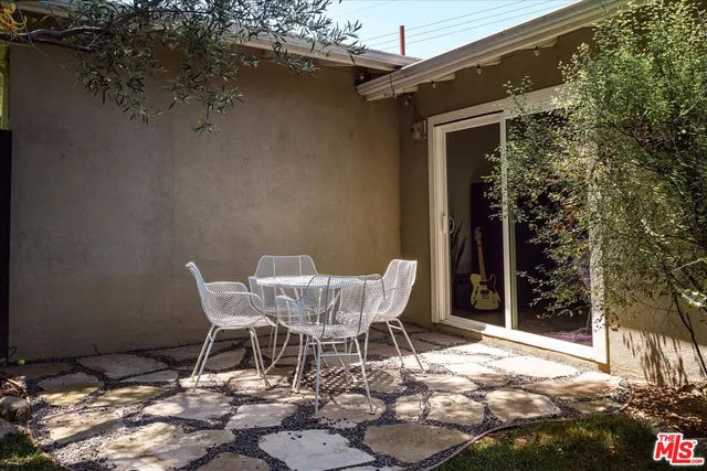 a view of a chairs and table in backyard