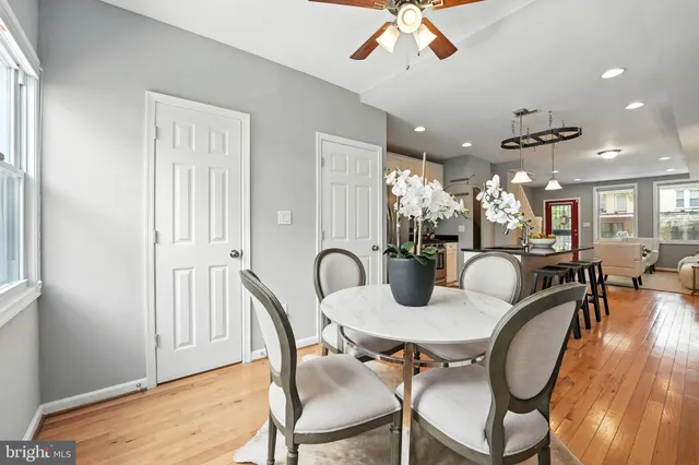 a dining room with furniture a window and wooden floor