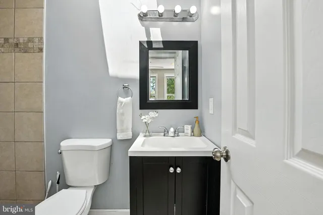 a bathroom with a toilet sink and mirror