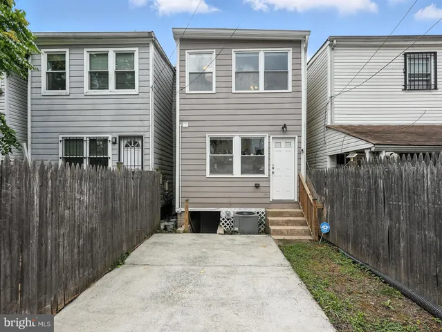 a view of a house with wooden fence