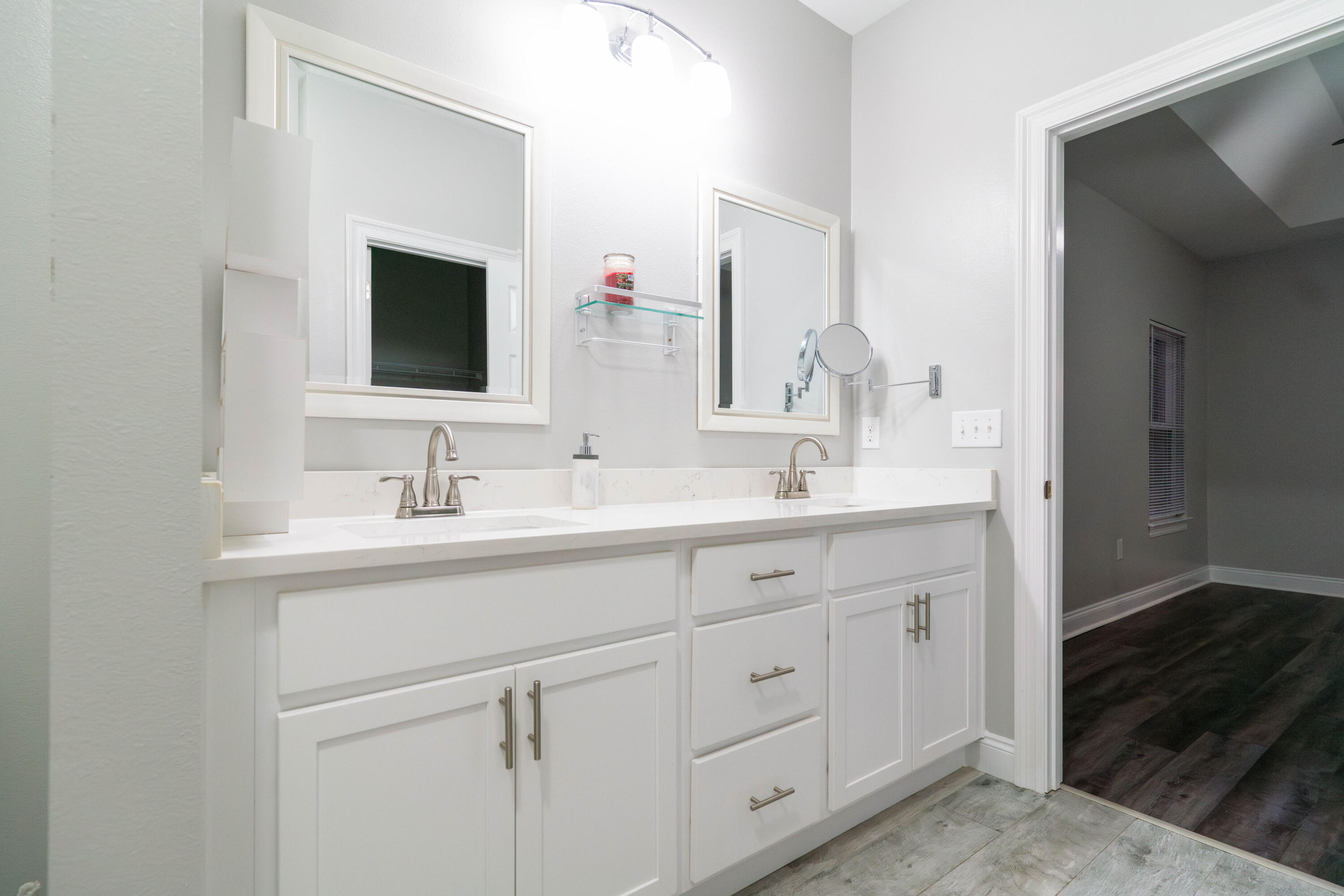 2243 Wind Trace Road North Navarre, FL 32566 - Photo 18 of 34 a bathroom with double sink and a mirror