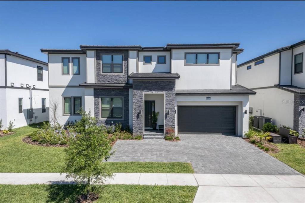 a front view of a house with yard and outdoor seating