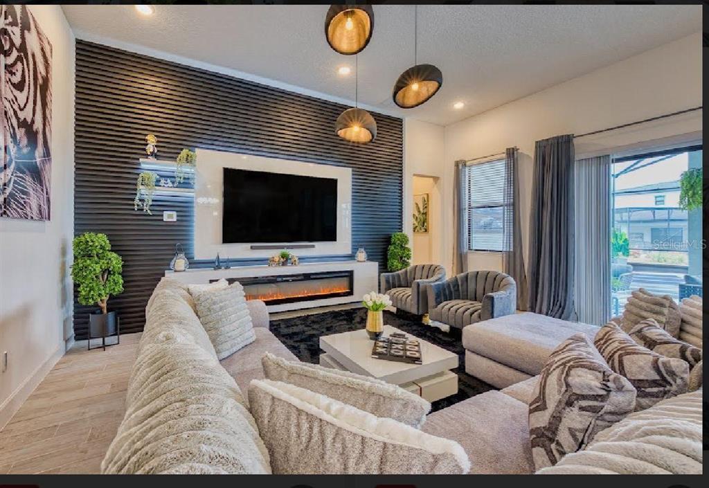 6301 Sand Skipper Road Orlando, FL 32821 - Photo 12 of 80 a living room with furniture and a flat screen tv