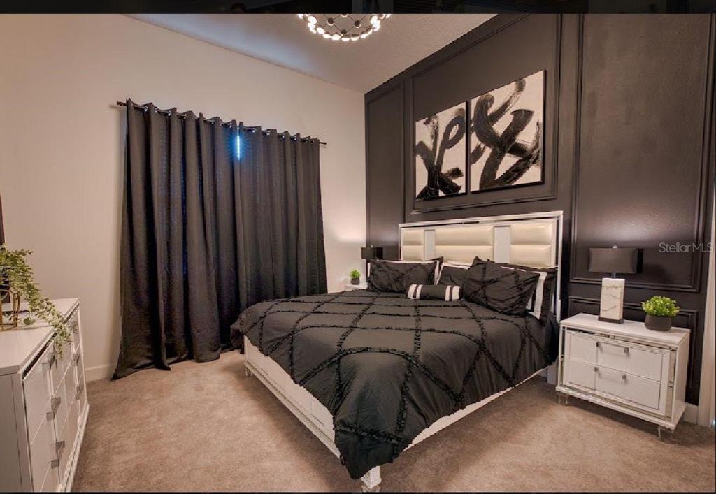 6301 Sand Skipper Road Orlando, FL 32821 - Photo 18 of 80 a bedroom with a bed and a painting on the wall