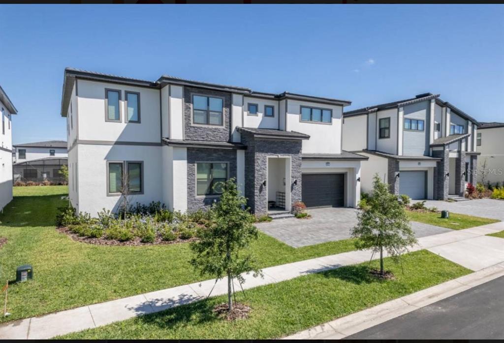 6301 Sand Skipper Road Orlando, FL 32821 - Photo 2 of 80 a front view of a house with garden