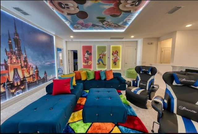 a bedroom with a bed and a flat tv screen on dresser