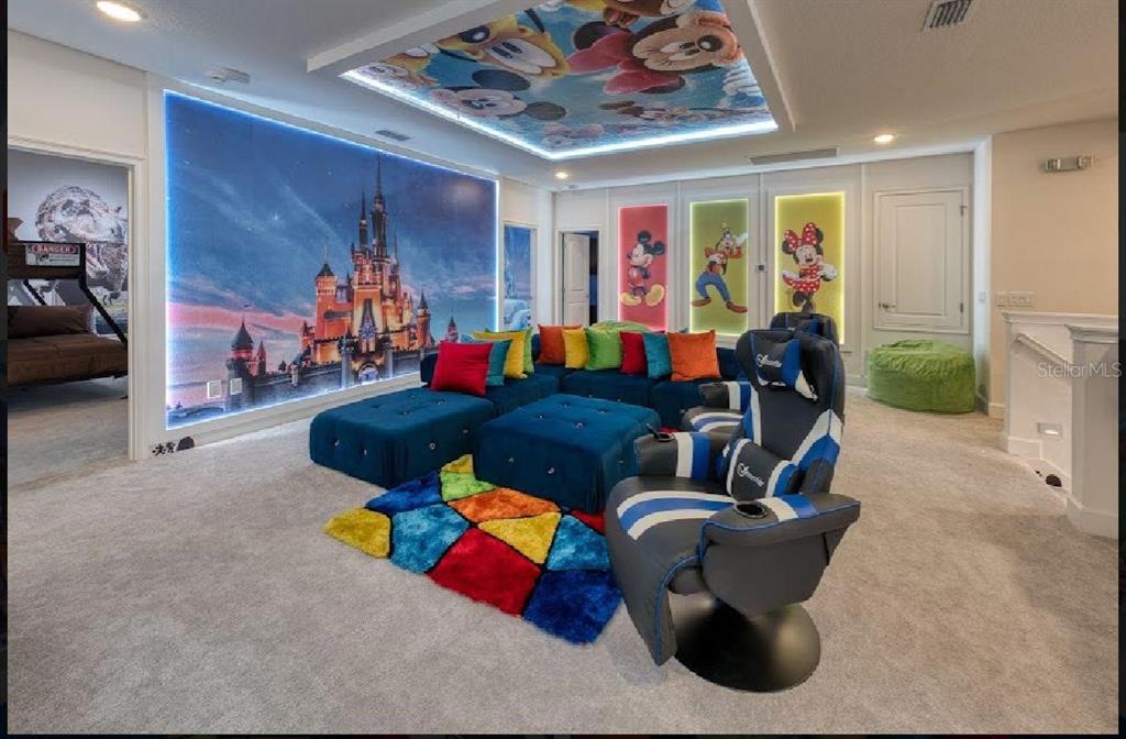 6301 Sand Skipper Road Orlando, FL 32821 - Photo 30 of 80 a living room with furniture and a flat screen tv