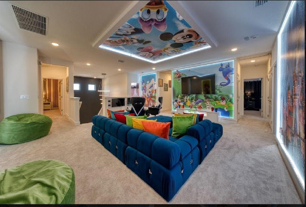 6301 Sand Skipper Road Orlando, FL 32821 - Photo 33 of 80 a living room with furniture kitchen and a chandelier